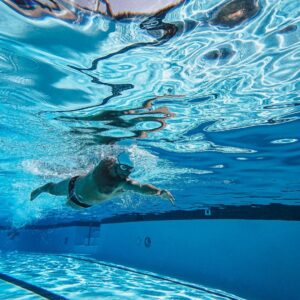 A woman swimming laps in a pool.