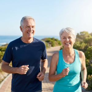An elderly couple walking outside together.